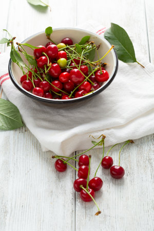 Summer cherry in enamel bowl for pie, homemade dessertの写真素材