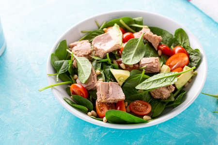 Close up of tuna and avocado salad in white bowlの写真素材