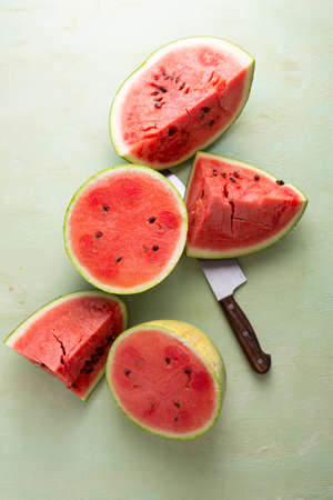 Sliced watermelon on light green surfaceの写真素材