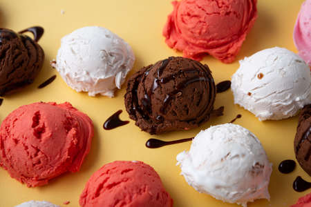 Scoops of gelato on golden surface, ice creamの写真素材