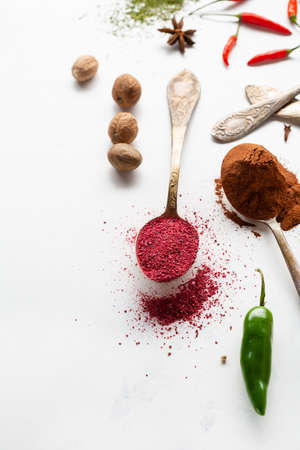 spice powder on spoons chilli pepper and nutmeg cinnamonの写真素材