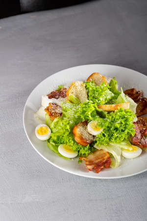 Close up of chicken, eggs and bacon salad on plate foodの写真素材