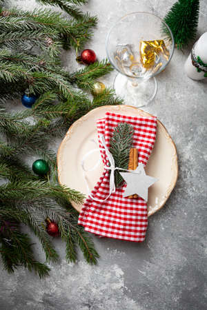 Christmas table setting with plate and wine glassの写真素材