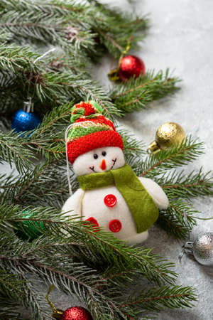 Holiday concept funny snowman and green branchesの写真素材