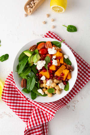 Butternut pumpkin salad with feta and roasted chickpea healthy food on light surfaceの写真素材