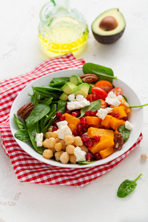 Close up Butternut pumpkin salad with feta and roasted chickpea healthy food bowl avocadoの写真素材