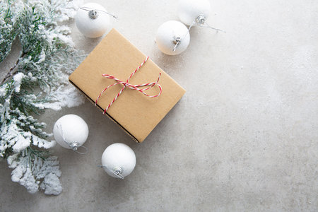 Overhead view of Christmas present paper box and green branchesの写真素材