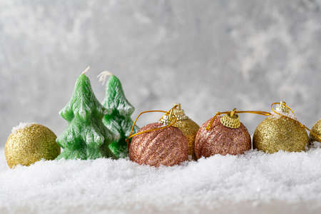Christmas tree candles and decorations on snow festive conceptの写真素材