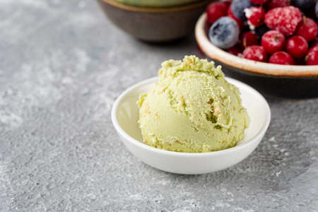 Close up of one scoop pistachio ice cream in bowlの写真素材