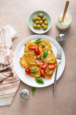 Vegan potatoes fritters with tomatoes top view foodの写真素材