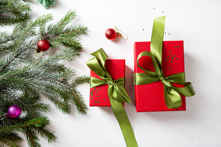 Top view of two red Christmas boxes and holiday decorations copy spaceの写真素材