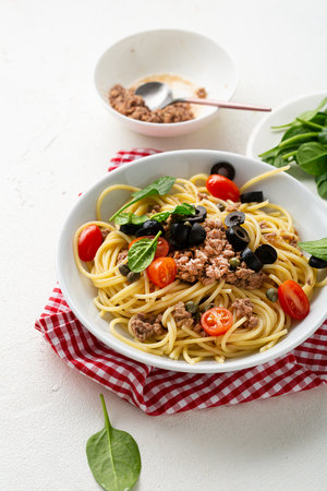 Close up of canned tuna spaghetti in bowl food tomato balck oliveの写真素材