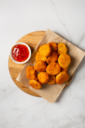 Top view of nuggets and red dip light surface fast foodの写真素材