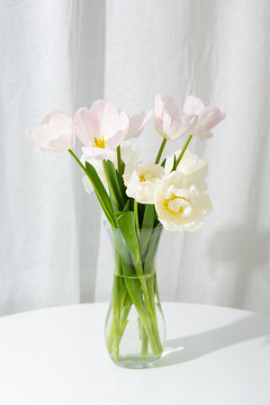 Light spring flowers in vase on tableの写真素材