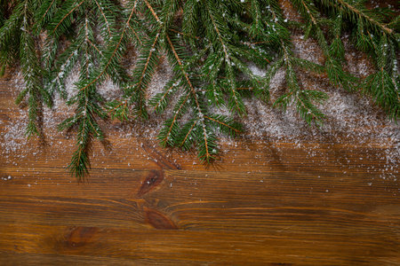 Wooden Christmas background with green spruce snow copy spaceの写真素材