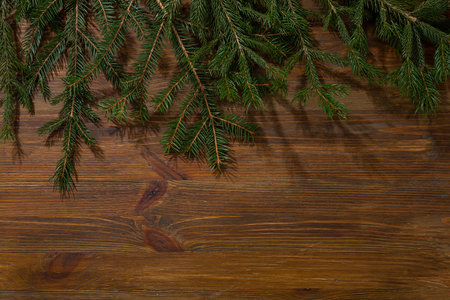 Wooden Christmas background with green spruceの写真素材