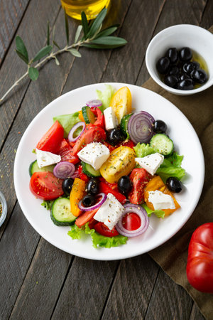 Fresh vegetable salad with feta olive food on wooden tableの写真素材