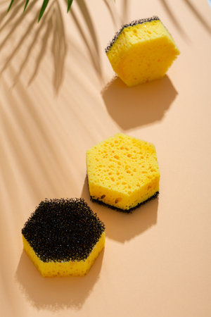 Still life with yellow household sponge on beige surfaceの写真素材