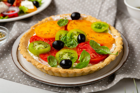 Close up of savory pie with cheese and tomatoes slice quiche on plateの写真素材