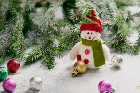 Christmas composition with snowman and green branches decorations ballsの写真素材