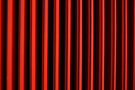 Graphic background red heater. Geometric, abstract photo. Intensely red backdrop
