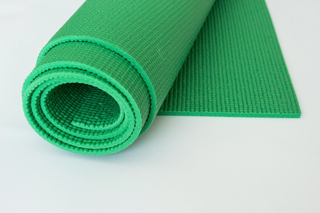 Green Yoga Mat on white background. Sport concept. の写真素材