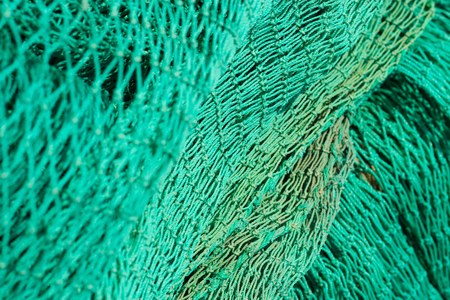 Green fishing net. Texture Close up. Simple background with selective focusの写真素材