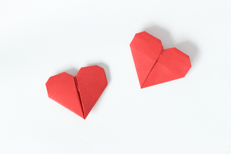 Two red origami hearts on white background. Valentin's Day gift cards. Top view.の写真素材