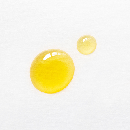 Drops of oil essence for face care on white backgroundの写真素材