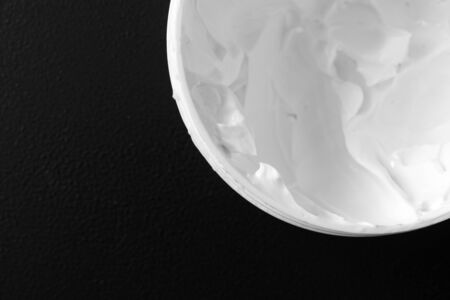 Moisturizer cream for body or face on black background, close-up, selective focusの写真素材