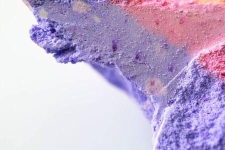 Macro piece of bath bomb with selective focus on white backgroundの写真素材
