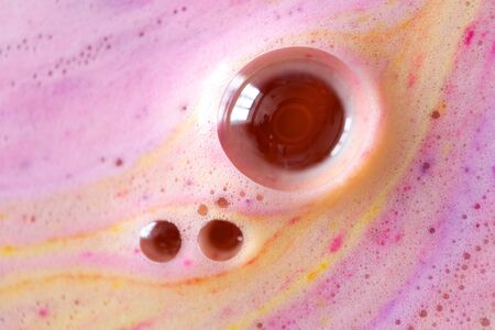 Foam with round bubble of bath bomb close-up colorful backgroundの写真素材