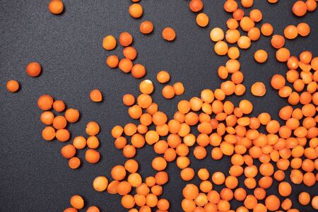 Red lentils on black background, high-protein food, close-upの写真素材
