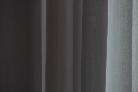 Closed white cotton curtains with daylight passing through them. The atmosphere of peace and...