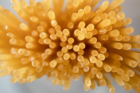 Italian uncooked spaghetti, top view. Texture of pasta with selective focus viewed from above,...