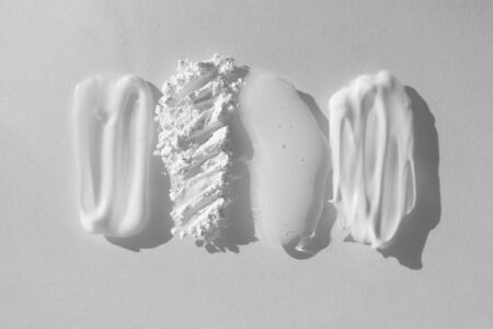 Smears of different beauty product. Moisturizer cream, translucent loose powder, soap, facial mask...