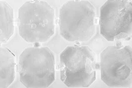 Macro ice cubes in plastic form, top view. Homemade ice