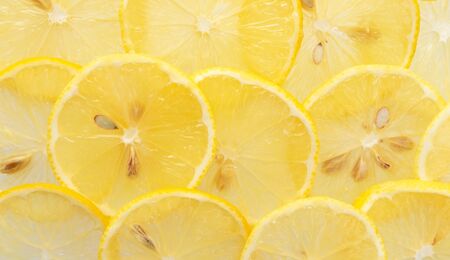 Macro yellow lemon slices pattern, top view. Fresh juicy food concept, banner formatの写真素材