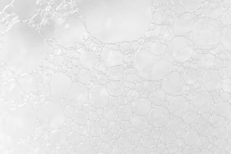 Soap or shampoo foam texture with selective focus, close-up. Macro bubbles white backgroundの写真素材