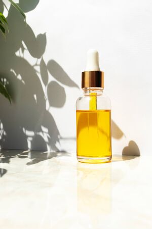 Oil serum with vitamin E in glass bottle. Skin care beauty product. Anti age face moisturizer. Concept natural and organic cosmeticの写真素材