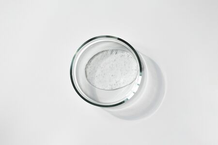 Transparent gel with air bubbles in glass petri dish on white background. Concept laboratory tests...