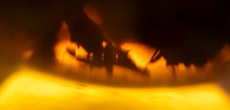 Defocused brewing black tea. Yellow brown abstract horizontal banner format