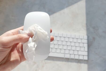 Cleaning and disinfect computer accessories with antiseptic wipes, top view. Hygiene workplace at...