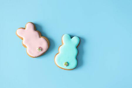 Homemade Easter cookies rabbit shape on blue background with copy space. Easter food traditionの写真素材