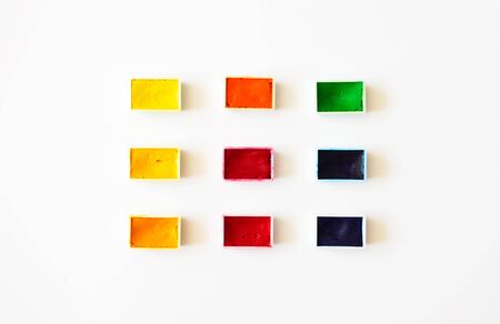 Colorful watercolor palette on white background flat lay, top view. Concept creative and art