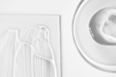 Close-up aloe gel in glass petri dish and transparent skin care lotion on glass on white background, above. Pure texture hydration shampoo or maskの写真素材