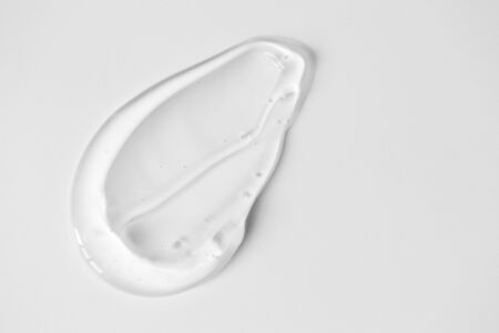 Close-up aloe gel smear on white background and copy space. Pure transparent facial cleanser,...