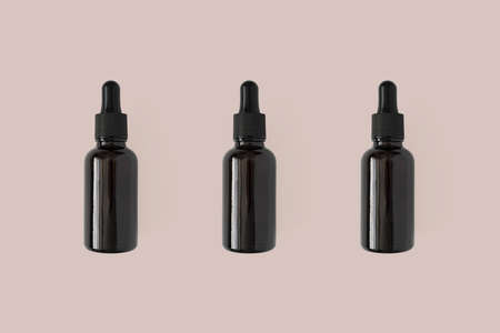 Mockup for collagen moisturizer, facial essence oil, vitamin E bottle skincare product. Serum in...