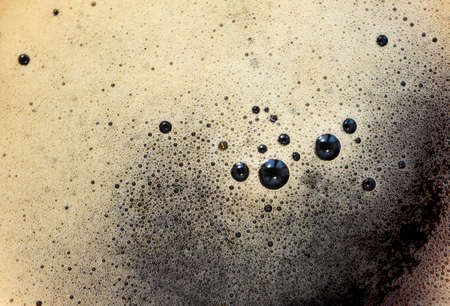 Drink surface with bubbles foam with selective focus, top view. Minimalist food background. Soft...