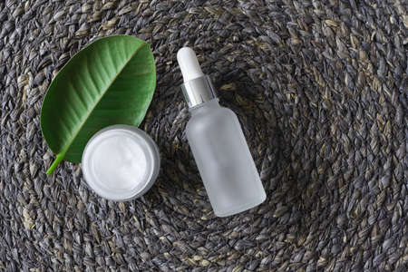 Eye care products eco natural extract concept, top view. Serum fluid dropper and moisturizer cream...